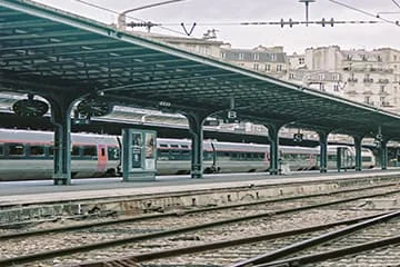 GareMontpellier Sud-de-France Façade d’une gare avec un large auvent et de grandes baies vitrées.